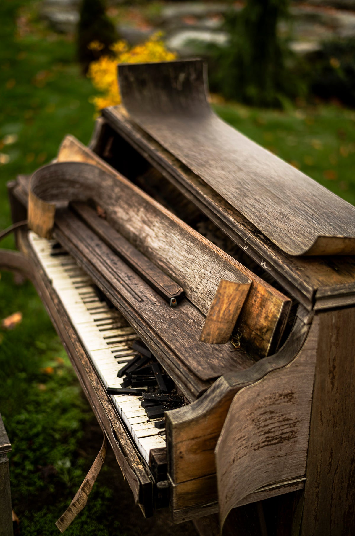 00_35 by Nick Patterson. A weathered upright piano photographed at an angle outdoors.
