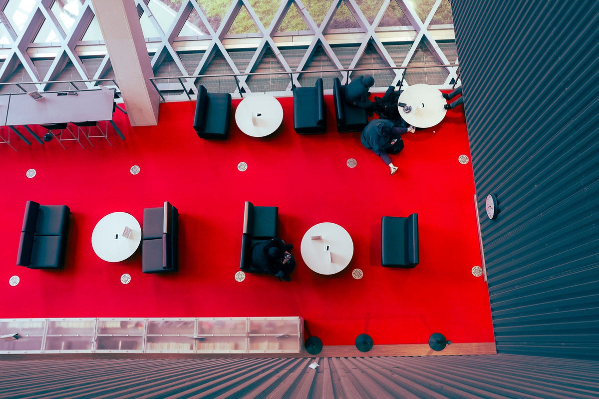 00_23 by Nick Patterson. Tables and chairs on a vivid red terrace, seen from above.