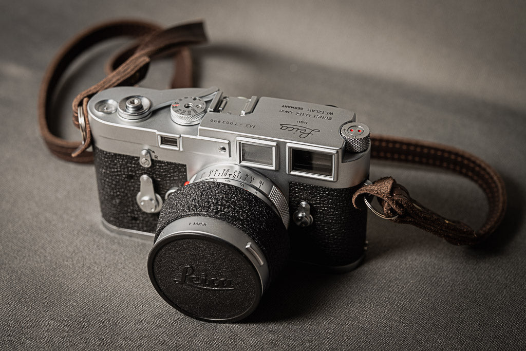 Chrome Leica M3 with 50mm Summilux and brown strap.