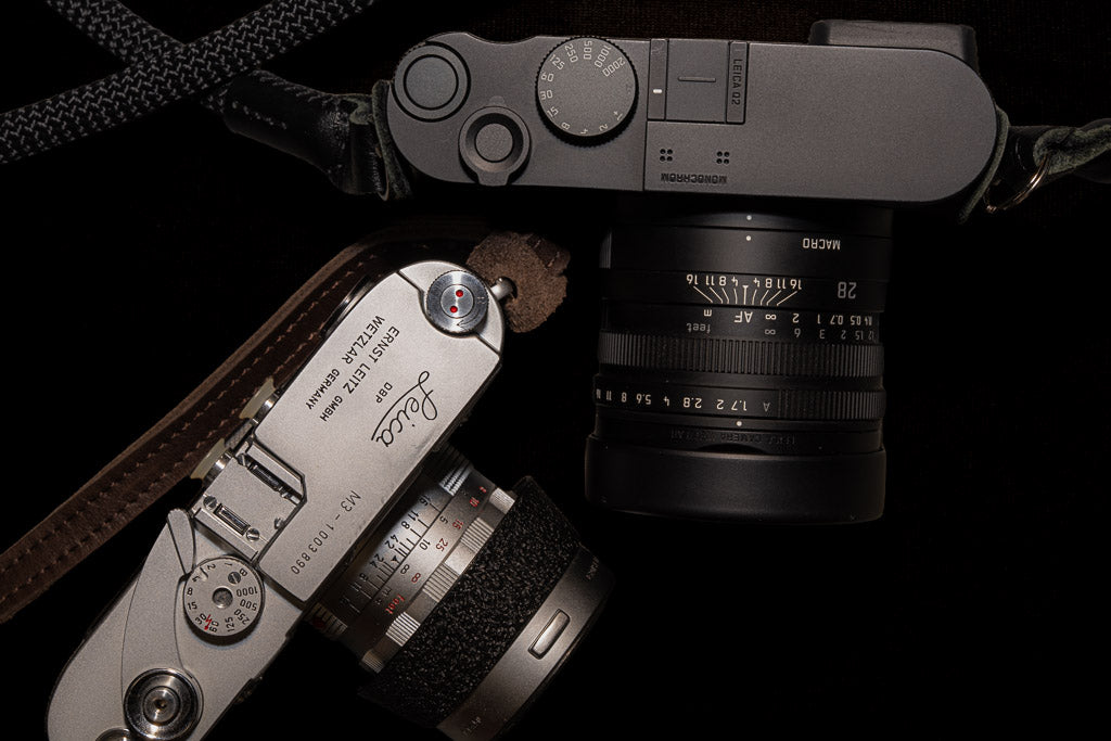 Leica Q2 Monochrom and Leica M3 photographed together from above.