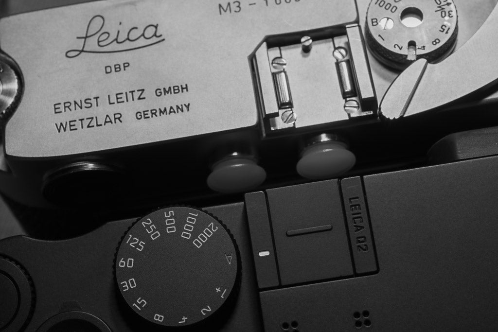 Black-and-white detail of the Leica M3 and Q2 Monochrom top controls.
