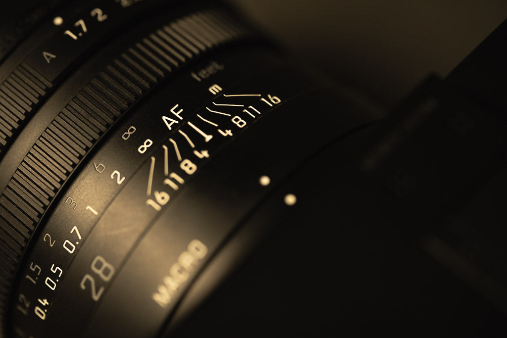 Close-up of the Leica Q2 Monochrom lens focus and aperture markings.