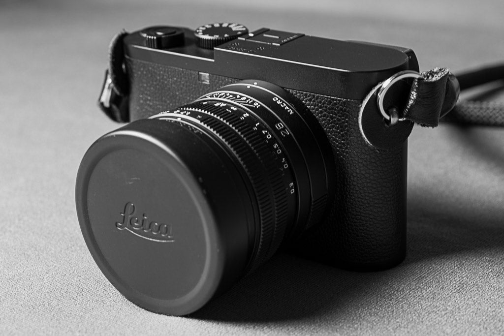 Leica Q2 Monochrom viewed from the front with lens cap on.