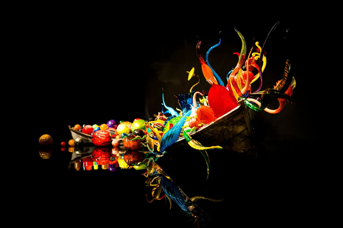 00_01 by Nick Patterson. Colorful glass forms reflected against a black background.